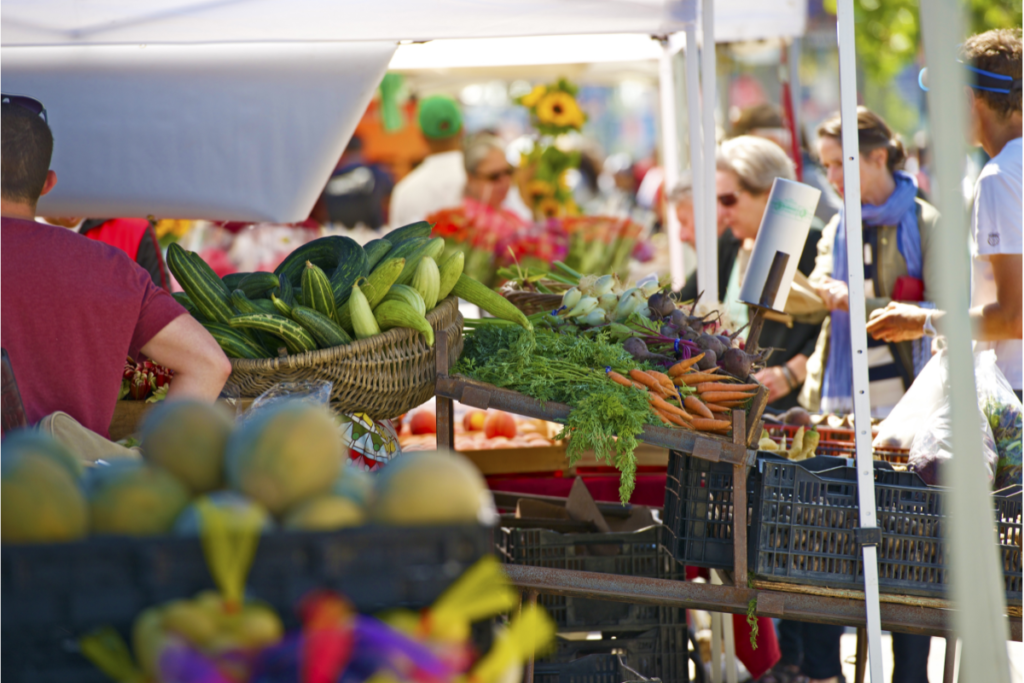 Vendors and people shopping at a farmers market