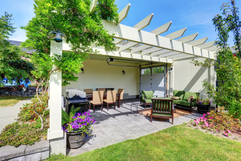 Covered patio area with outside chairs in the backyard garden. House exterior. Northwest, USA