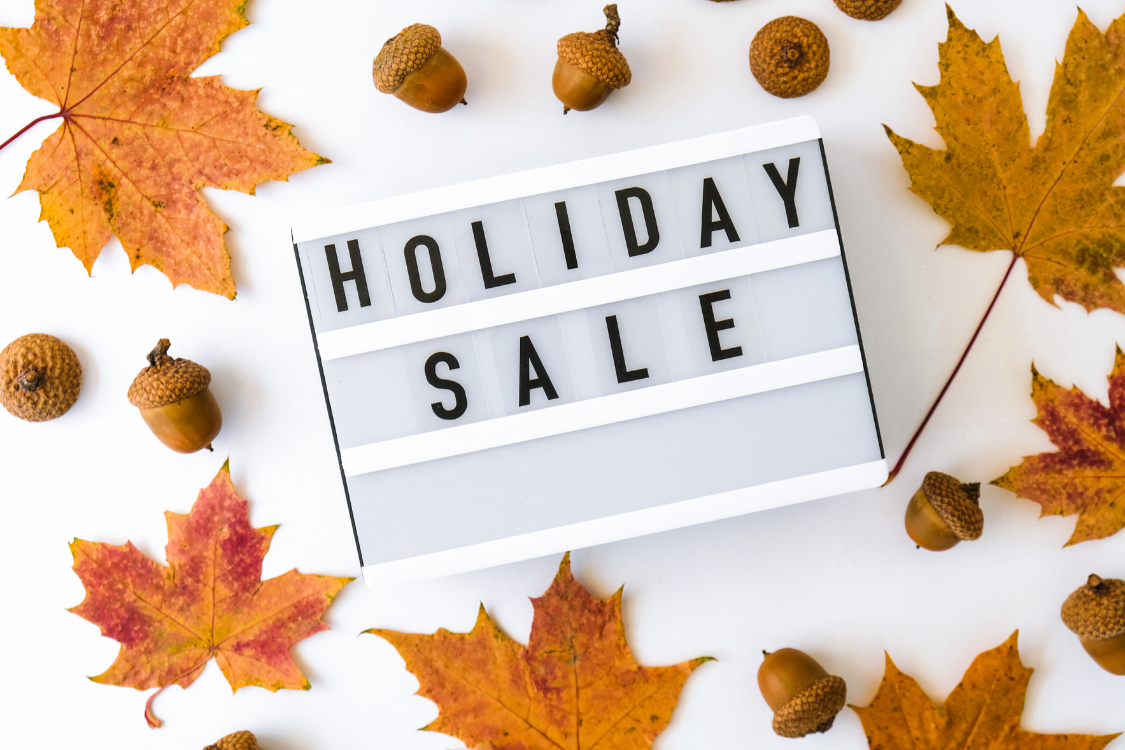 Holiday Sale words surrounded by leaves and acorns