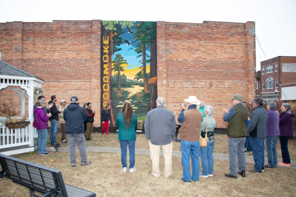Colorful mural in downtown Pocomoke City painted on the side of Cypress Roots Brewing Company, featuring imagery that celebrates family, cultural roots, and Native heritage. Artwork by We Are Limitless Studios. Photo by Wulfhouse Productions.