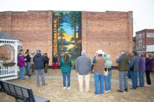 Colorful mural in downtown Pocomoke City painted on the side of Cypress Roots Brewing Company, featuring imagery that celebrates family, cultural roots, and Native heritage. Artwork by We Are Limitless Studios. Photo by Wulfhouse Productions.
