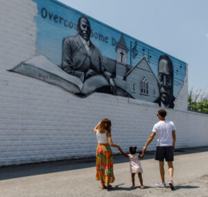 Family looking at the Tindley Mural in downtown Berlin, MD